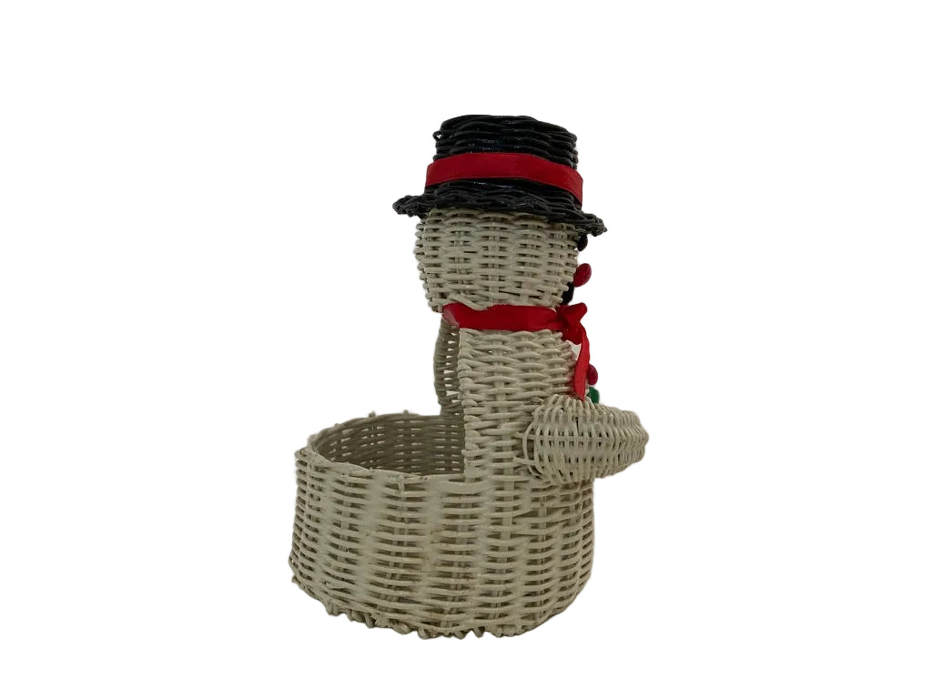 A snowman-shaped decorative basket made from woven natural wicker, wearing a black top hat with a red band and a red scarf.